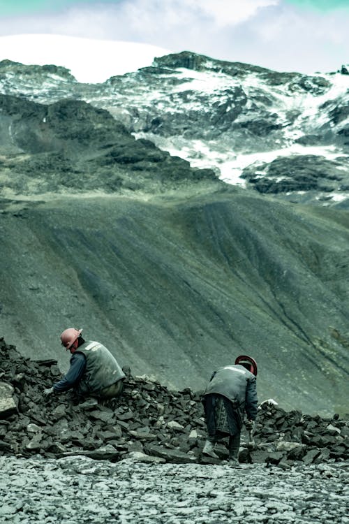 Gold Pickers Digging Through a Pile of Stones in Andes