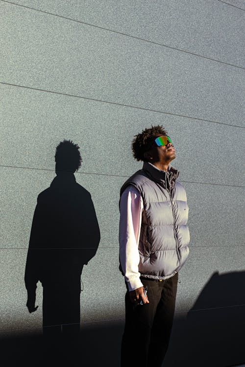 Man in Vest and Shadow on Wall