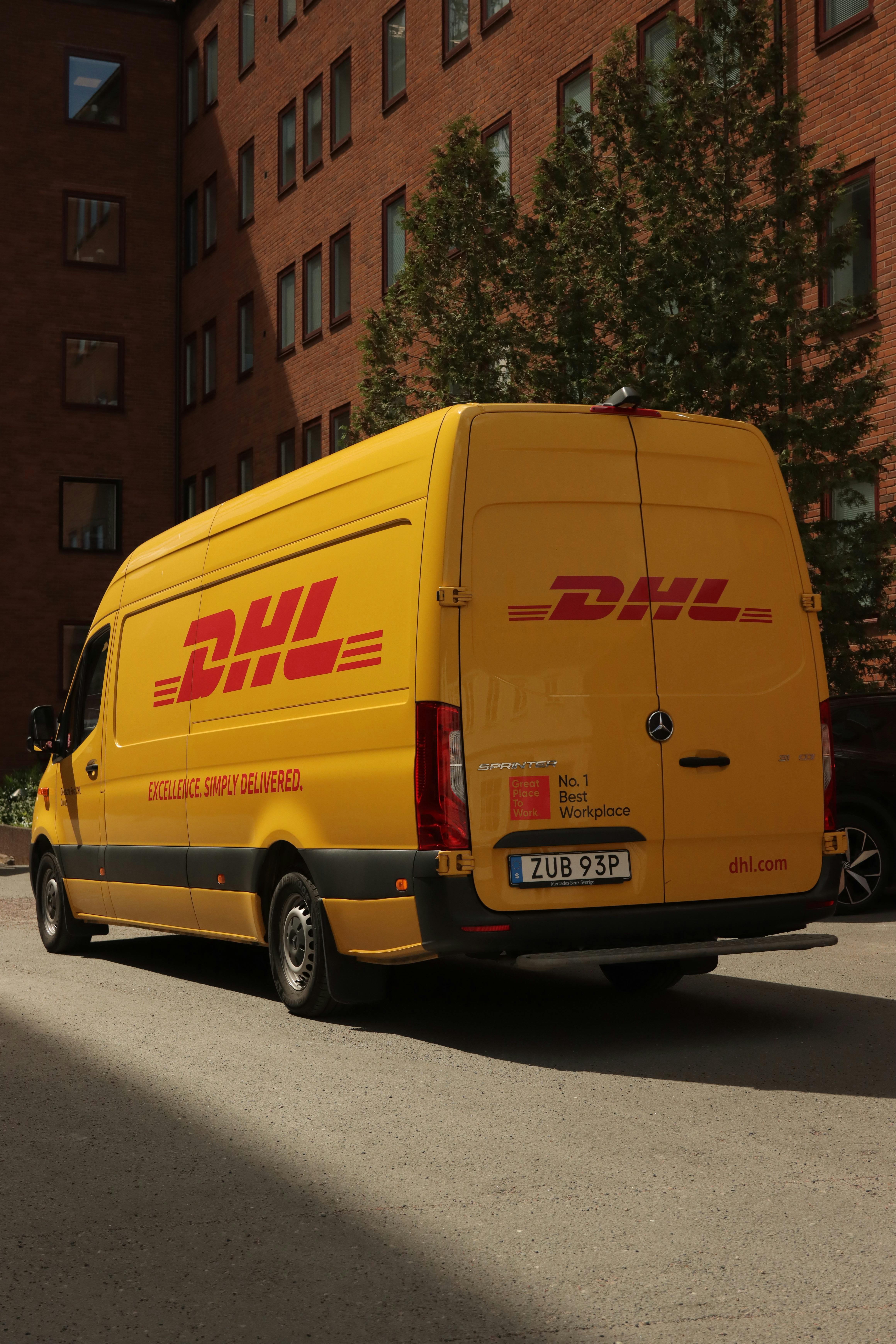 dhl yellow bus on street in sweden