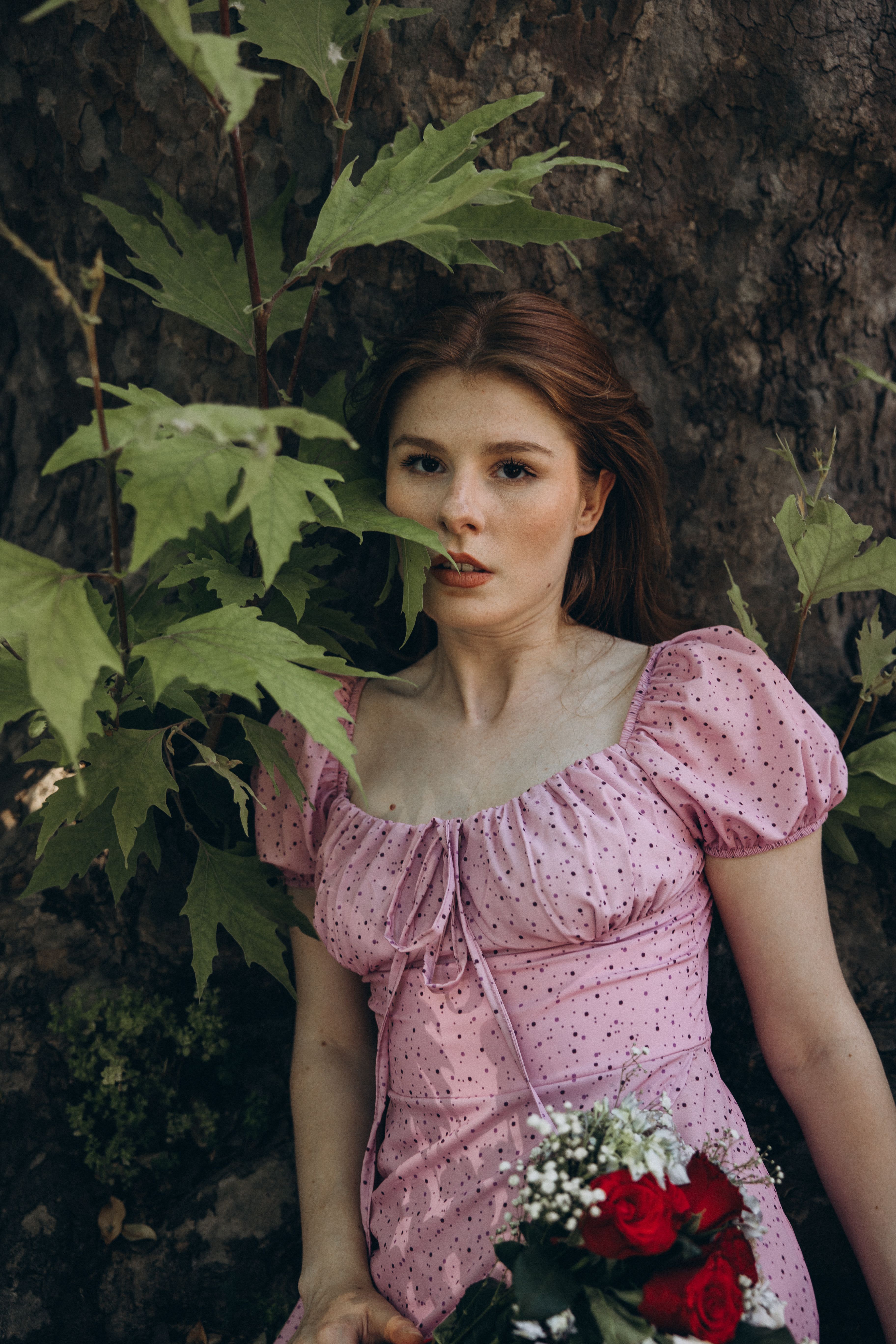 Elegant Woman in Pink Dress Holding Flowers Outdoors · Free Stock Photo