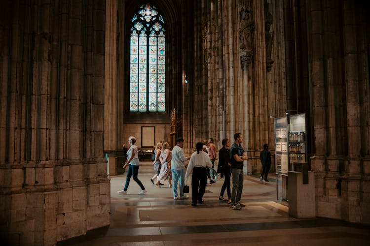 People Walking In Old Gothic Church