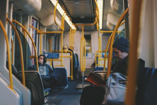 Commuters engaging in reading and relaxing on a modern Portland tram.
