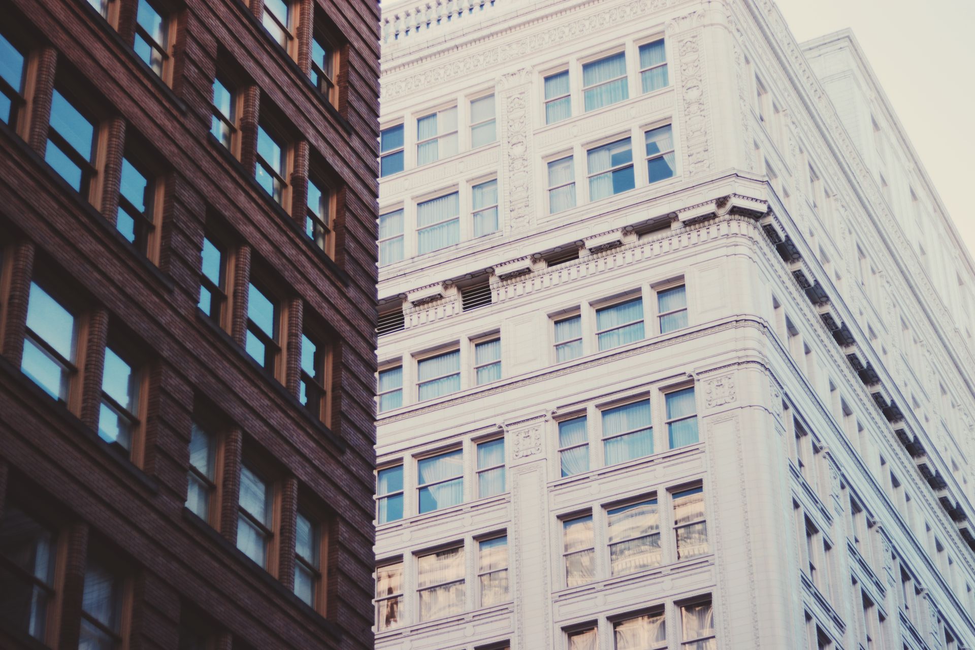 Modern urban architecture showing contrasting building styles with classic and modern office buildings.
