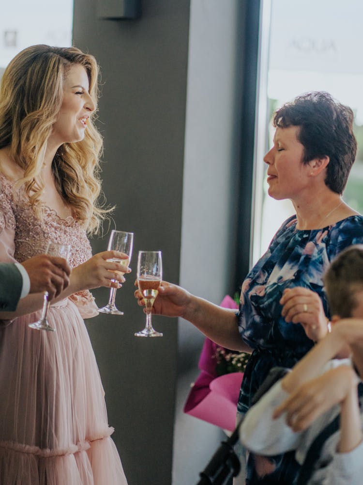 Women Clinking Champagne Glasses At A Party 