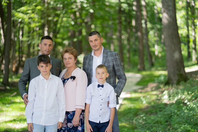 Family With Two Teenager Boys Posing At A Park