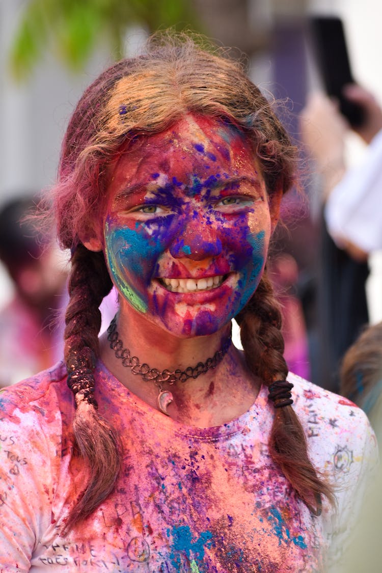 Teenager Girl Covered With Face Paint At A Festival Of Colors