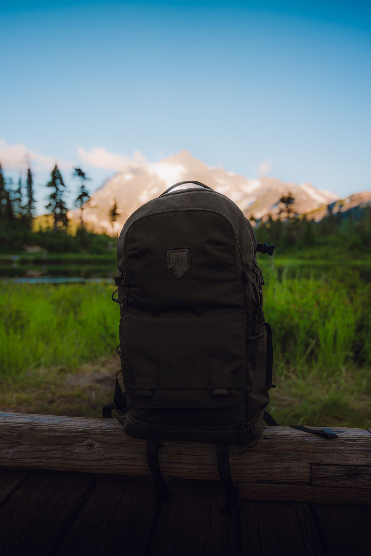 Travel backpack positioned in an open mountain landscape