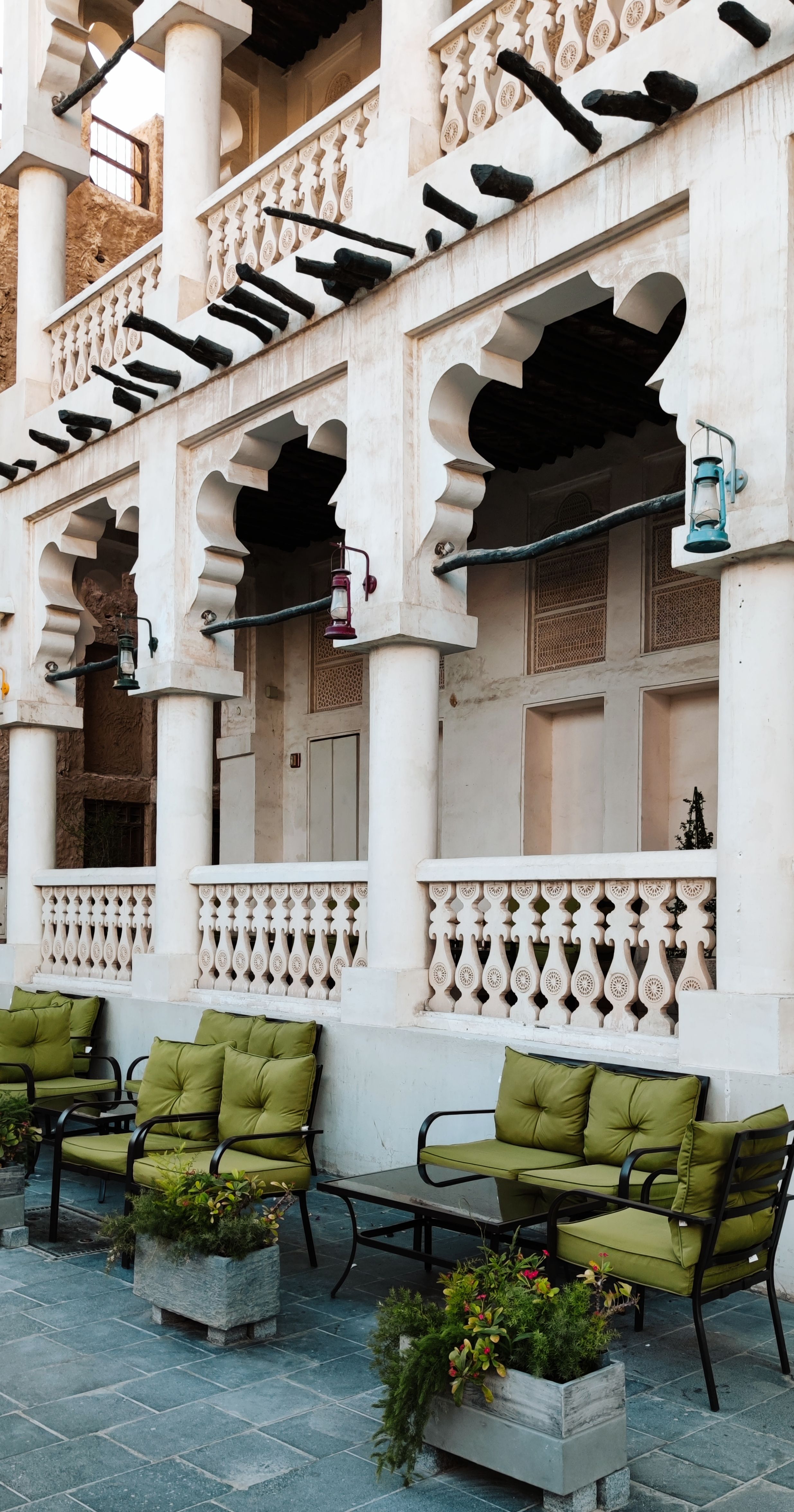 A charming traditional building facade with outdoor seating in Doha, Qatar.