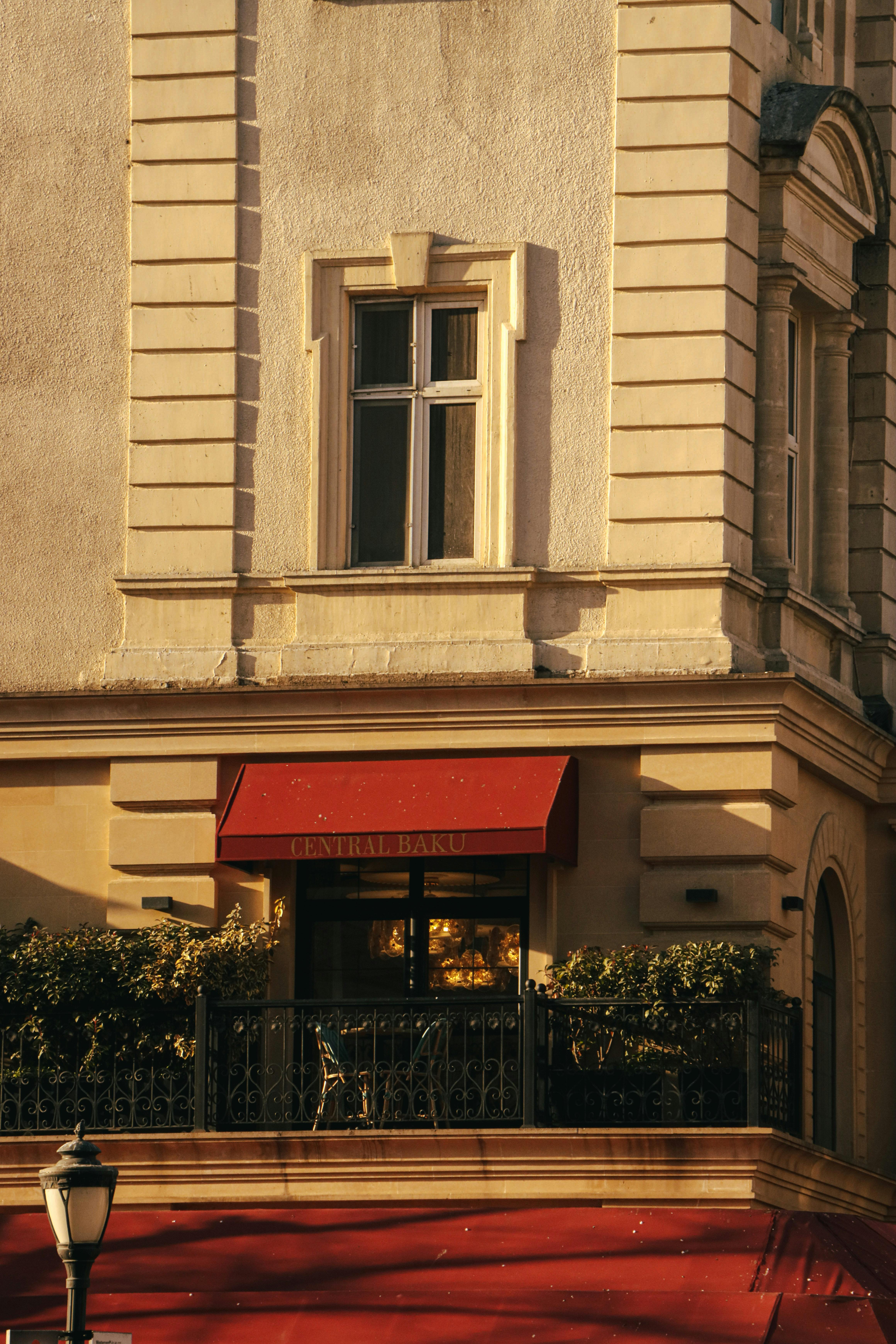 A red awning on a building with a balcony · Free Stock Photo