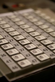 Detailed view of a multiplication table with QR codes on a calculator, showcasing numbers and technology.