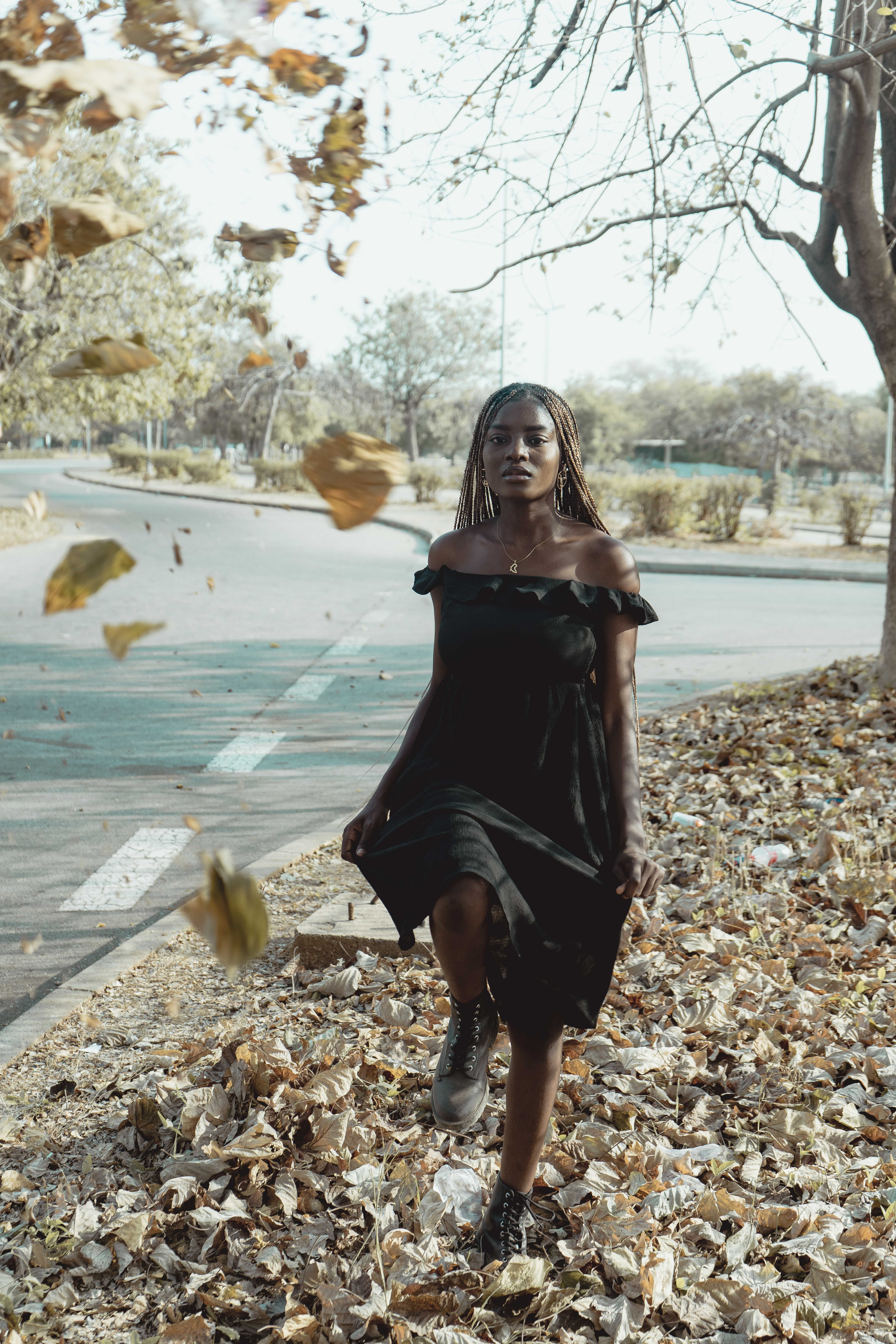 Woman in Black Dress Posing by Road in Autumn  Free Stock Photo