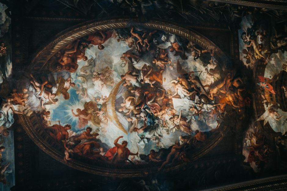Intricate Baroque ceiling mural depicting religious themes in historic church interior.