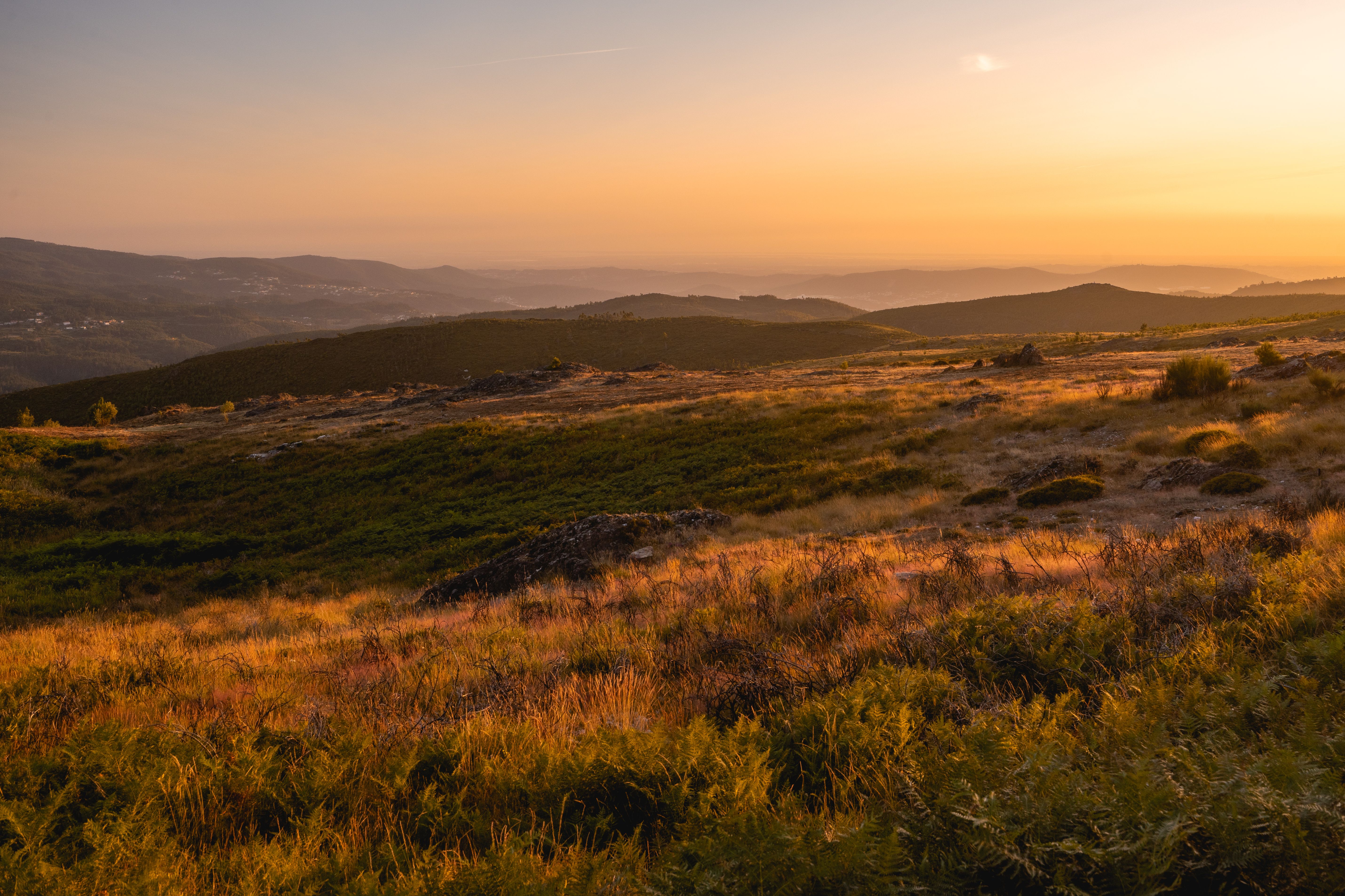 Captivating sunset over the rolling hills of Albergaria da Serra, Portugal, highlighting the tranquil autumn landscape.