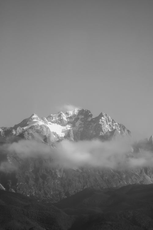 Free Stunning black and white photo of snow-covered mountains with clouds. Stock Photo