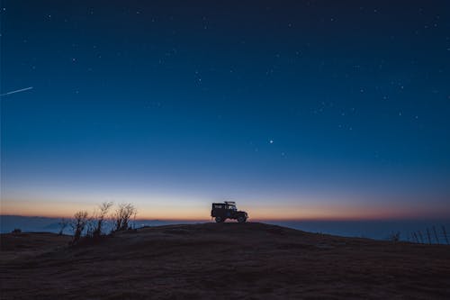 Land Rover on Top of a Hill at Dusk