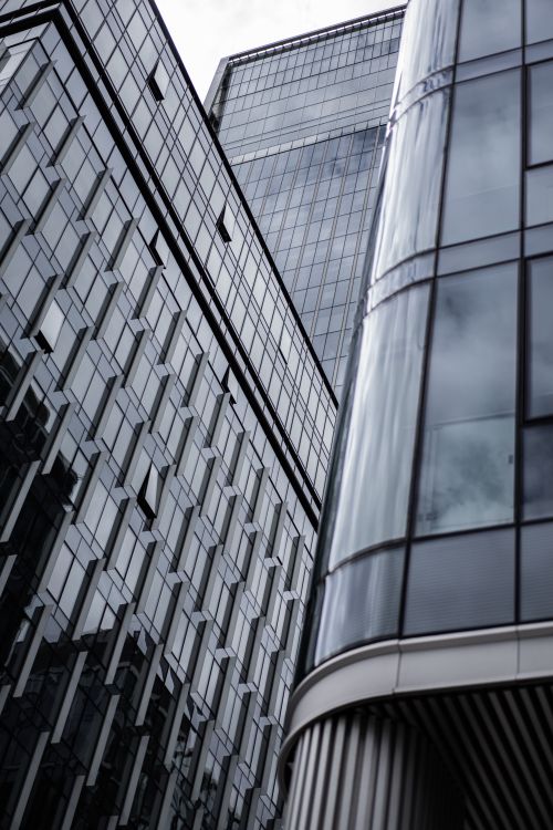 Free Low angle view of modern skyscrapers highlighting glass facades and contemporary architecture. Stock Photo