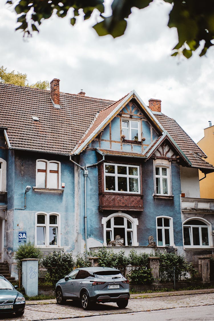 Modern Car Near Old Traditional House