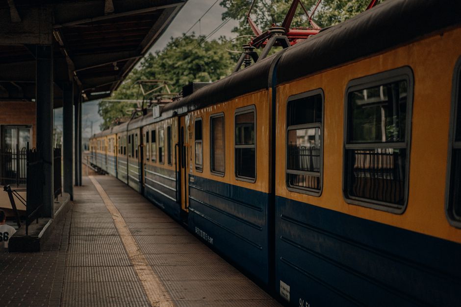 Modern interior of a PKP Intercity train in Poland, with comfortable seats and large windows.