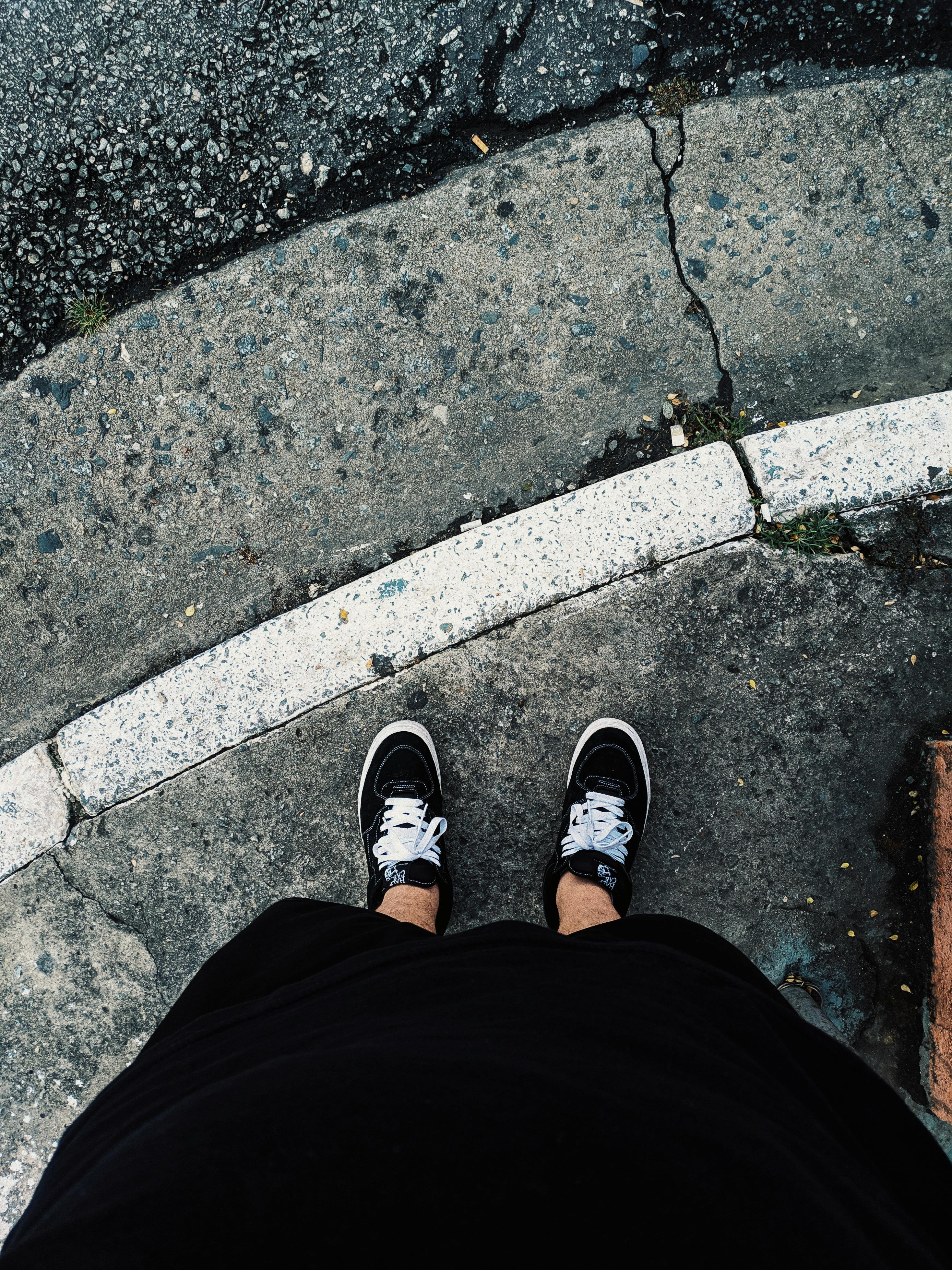 Person Wearing Black Low Top Sneakers · Free Stock Photo