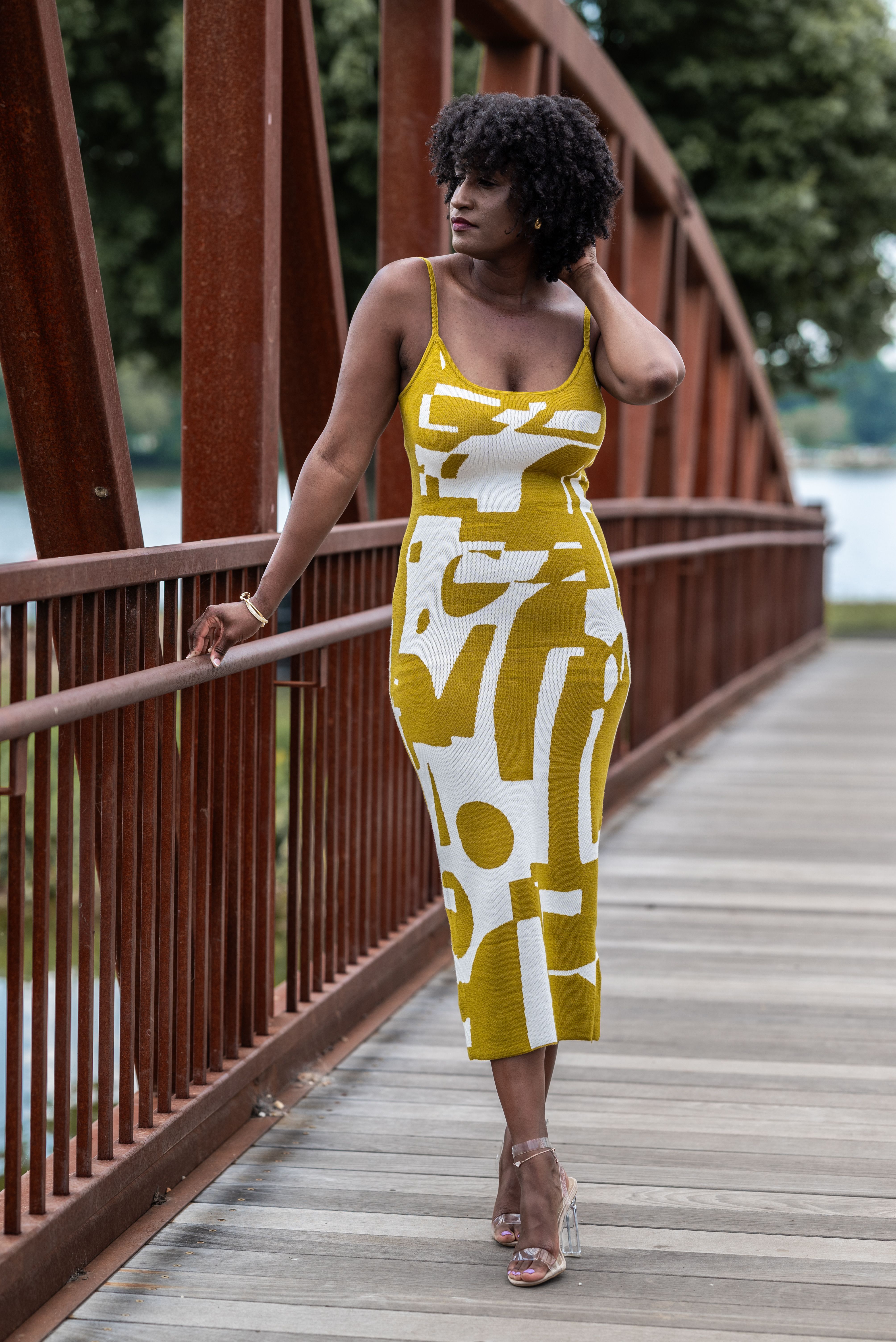 Woman Wearing an Elegant Patterned Dress Posing on a Footbridge · Free ...