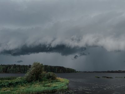 Dramatic sky with gray storm clouds over the lake