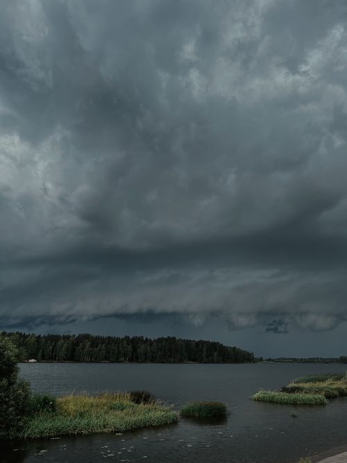 Dramatic Sky with Gray Storm Clouds over the Lake · Free Stock Photo