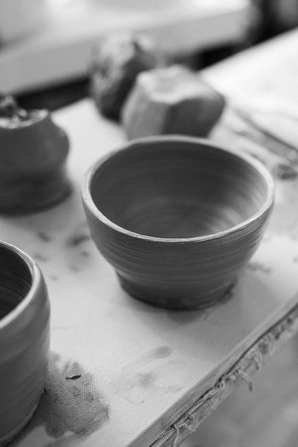 Close-up of a handmade empty clay pottery bowl in a studio setting.