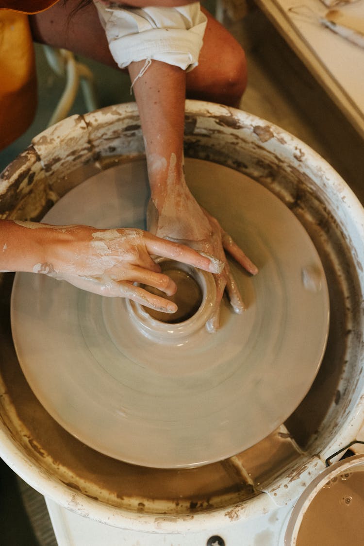 Potter Hands Working On Clay