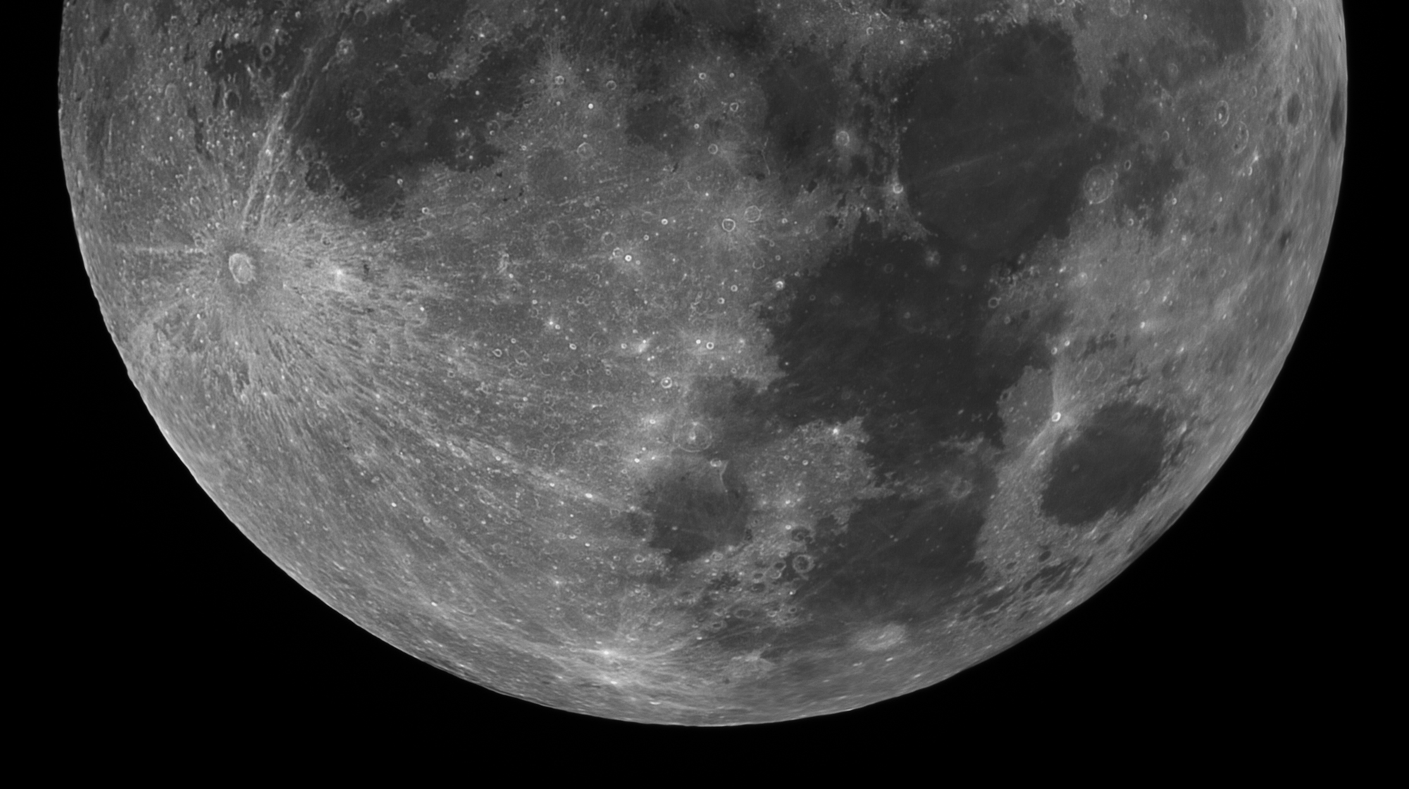 Close-up black and white photo of the moon showing lunar surface texture.