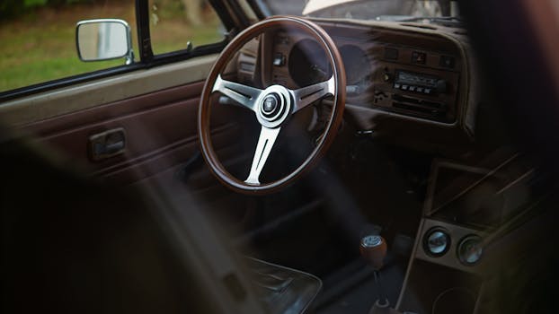 Explore the classic design of a vintage car interior featuring a retro steering wheel.