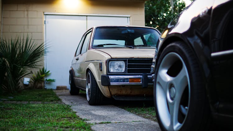 A Vintage Car Parked On The Driveway 