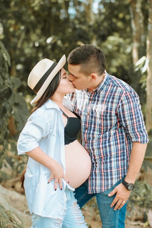 Man and Pregnant Woman Kissing
