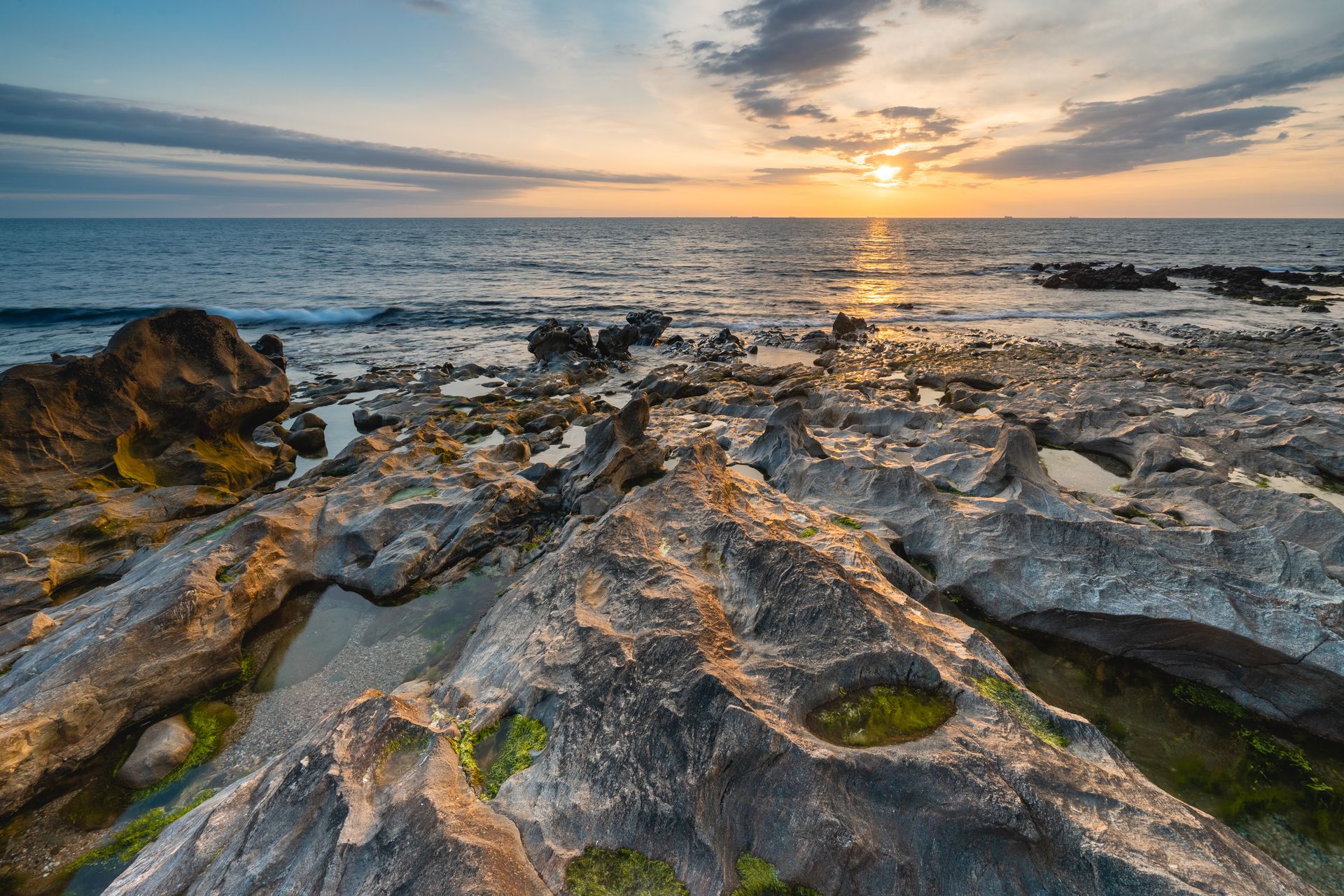 Sunset at the rocky beach at Vila Nova de Gaia, Portugal.