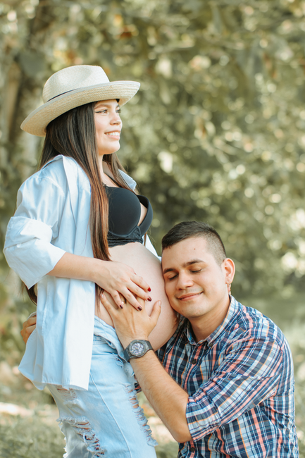 Warm scene of a happy couple embracing pregnancy in La Dorada, Colombia.