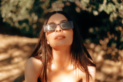 Young Woman in Sunglasses in Summer Park