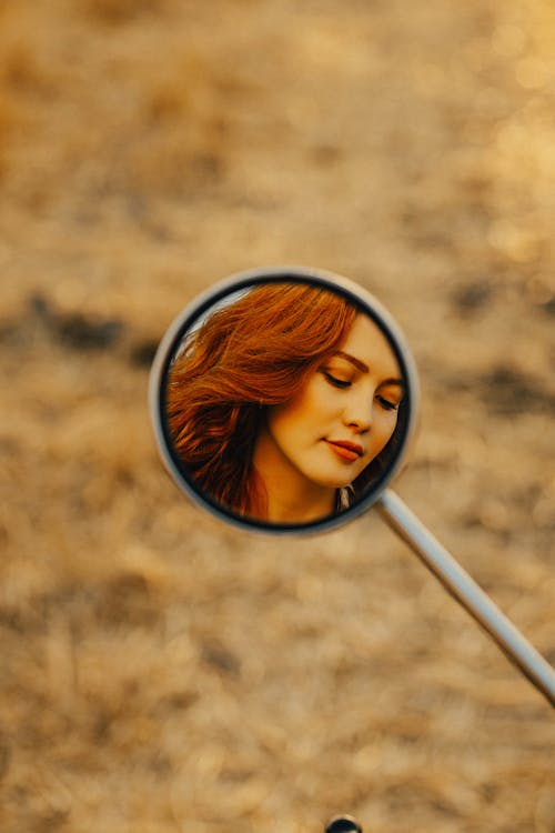 Woman Face Reflection in Motorbike Mirror