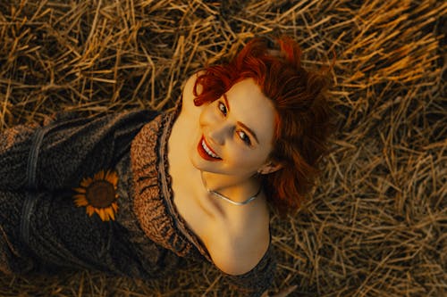Smiling Woman Lying Down on Field