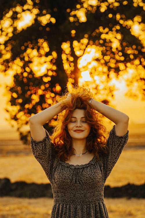 Portrait of Redhead Woman During Sunset 