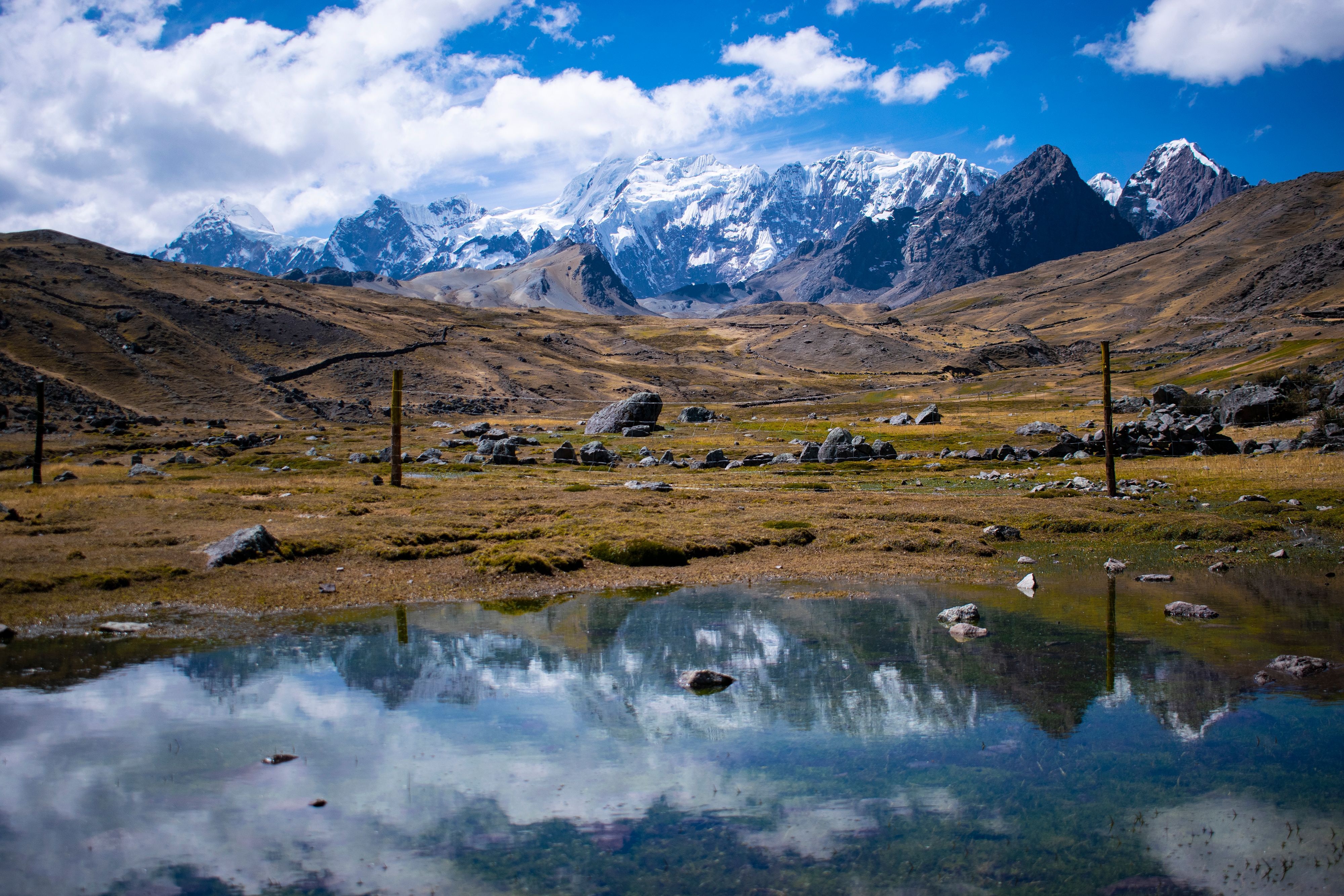Unbeatable Rainbow Mountain with Motorcycle with No Hiking Required Review: The Ultimate No-Hike Adventure in Peru Review 2026 - Majestic Andes mountains with snow peaks reflecting in a tranquil stream.