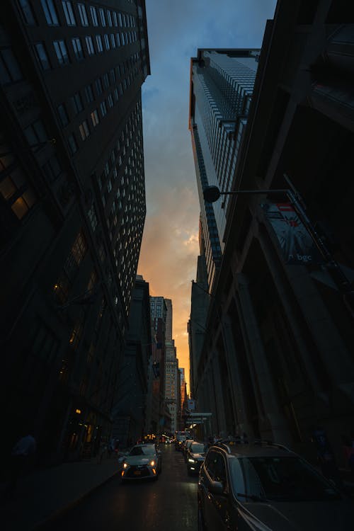 Darkness on Street under Skyscrapers at Sunset