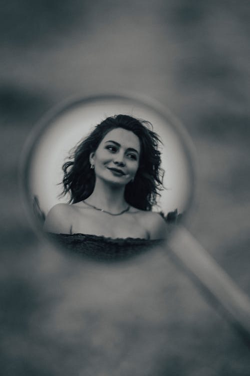 Smiling Woman Reflection in Car Mirror