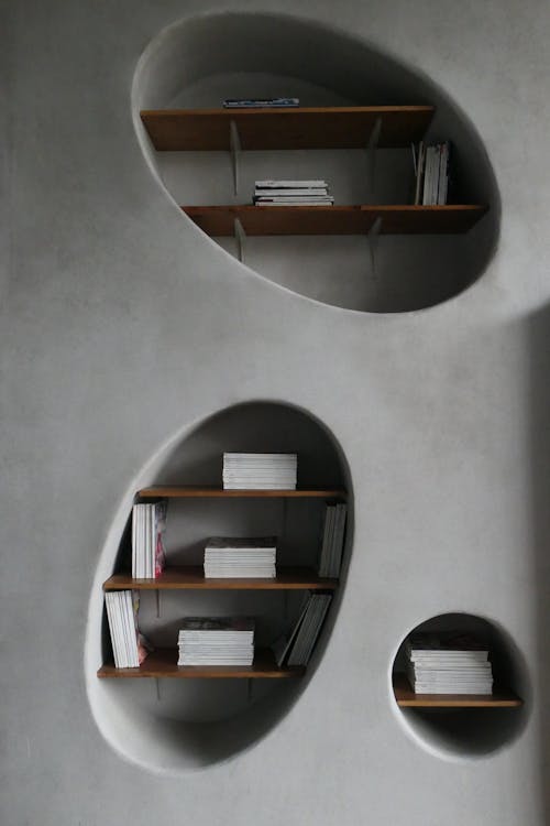 Books on Shelves in Gray Wall