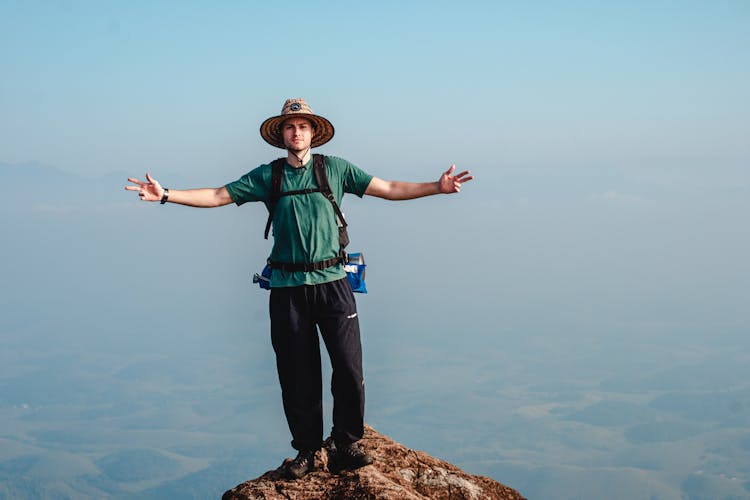 Man Posing On Rock Top Edge