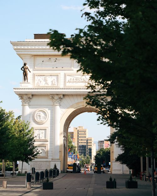 Free A beautiful view of Porta Macedonia with city elements in Skopje, perfect for travel and architecture themes. Stock Photo
