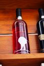 Wine bottles displayed on a wooden shelf, highlighting a rustic and elegant design.
