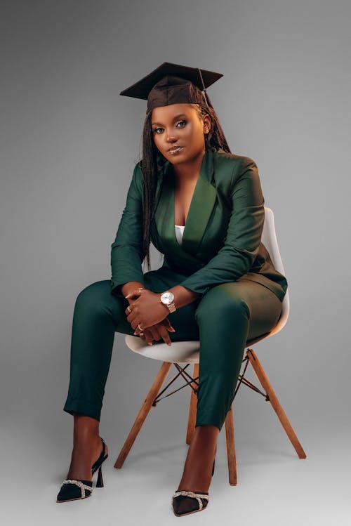 Woman Posing in Green Suit and Academic Hat