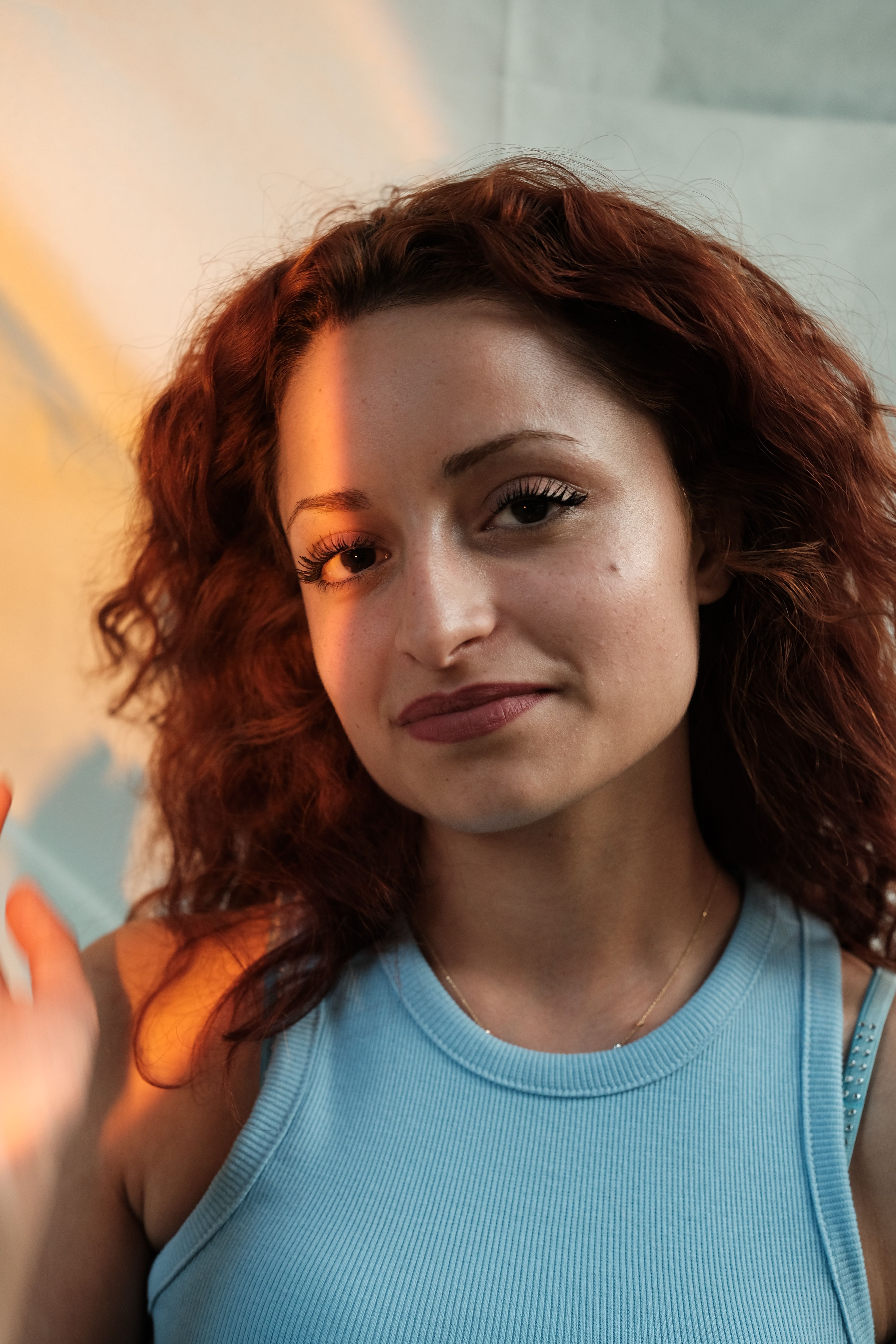 Portrait of a Young Smiling Woman with Wavy Hair · Free Stock Photo