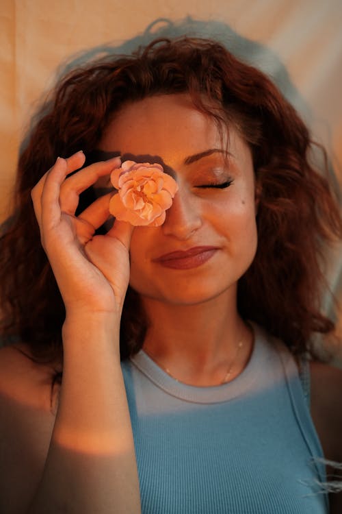 Woman with Eyes Closed and Flower over Face