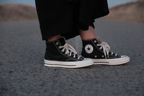 Close up of Woman in Converse Shoes on Asphalt Road