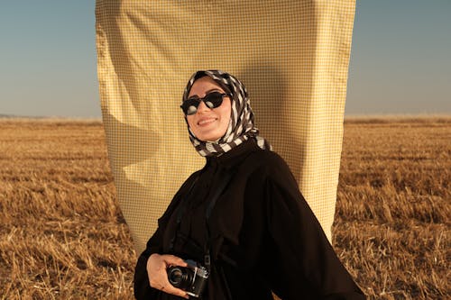 Portrait of Smiling Woman in Sunglasses and Hijab